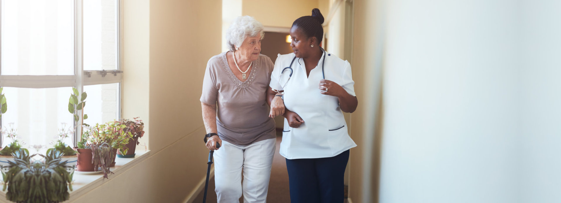 nurse and old woman talking
