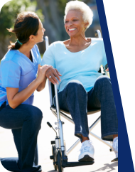 caregiver and old woman smiling at each other